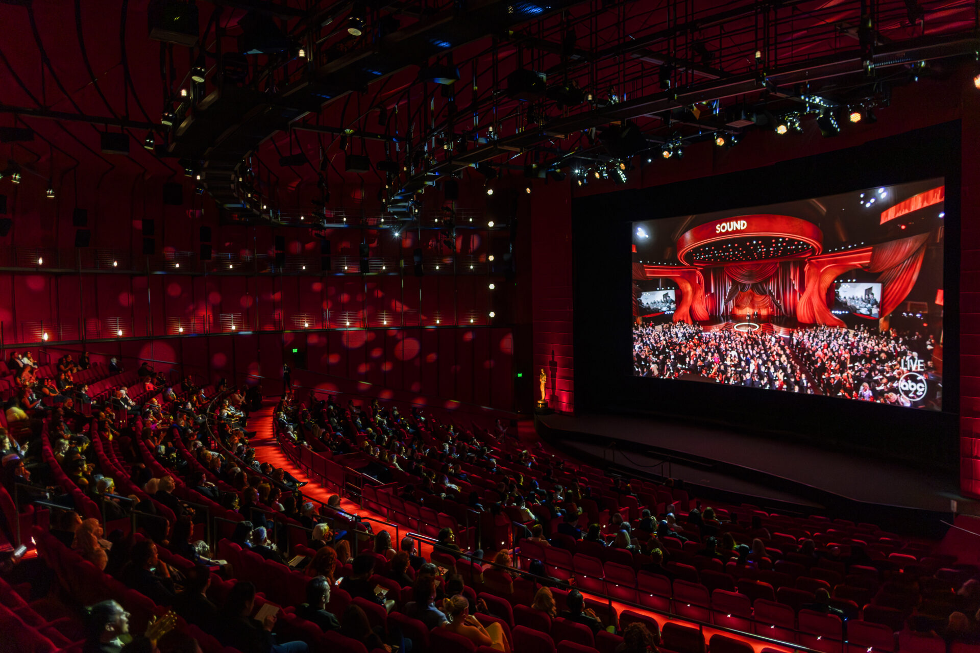 Guests watch the Oscars ceremony as it plays on a large screen.