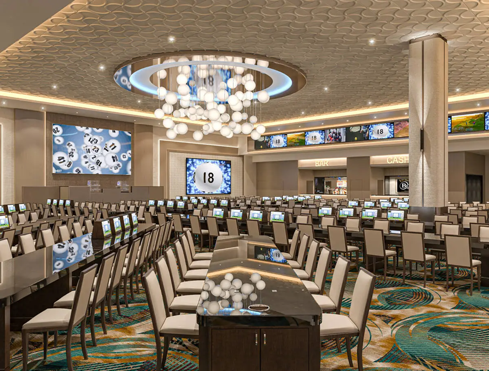 Long tables with chairs set with a screen displaying bingo numbers on it.
