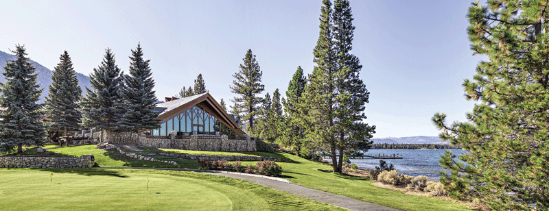 The resort with trees around it and a water body on one end.