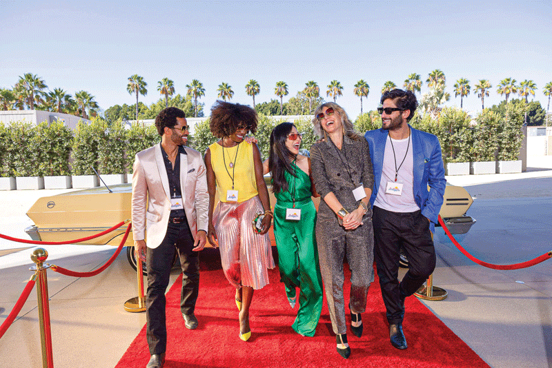 People walk the red carpet.