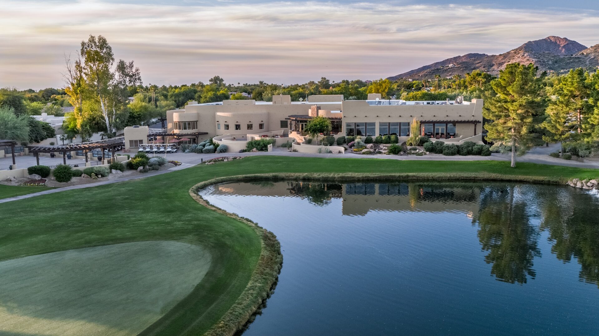 The golf course in the foreground with the resort building in the background.