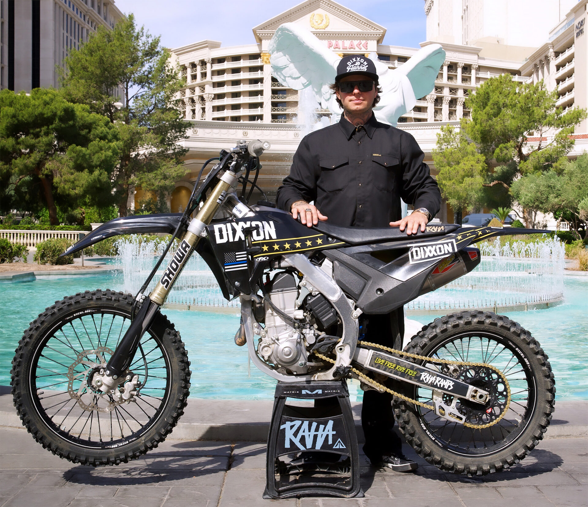 Colby Raha standing behind a bike.