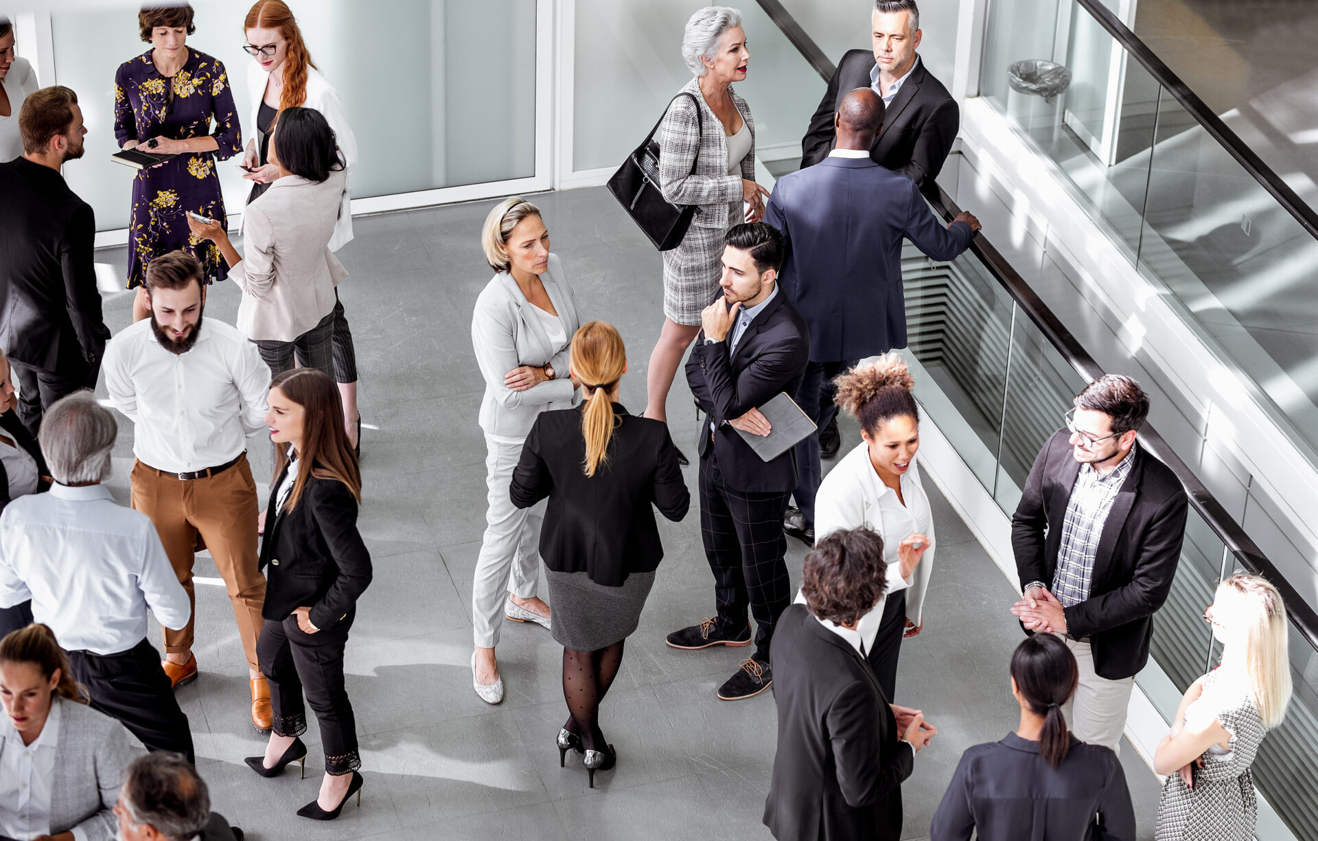 An overhead shot of people networking in a lobby.