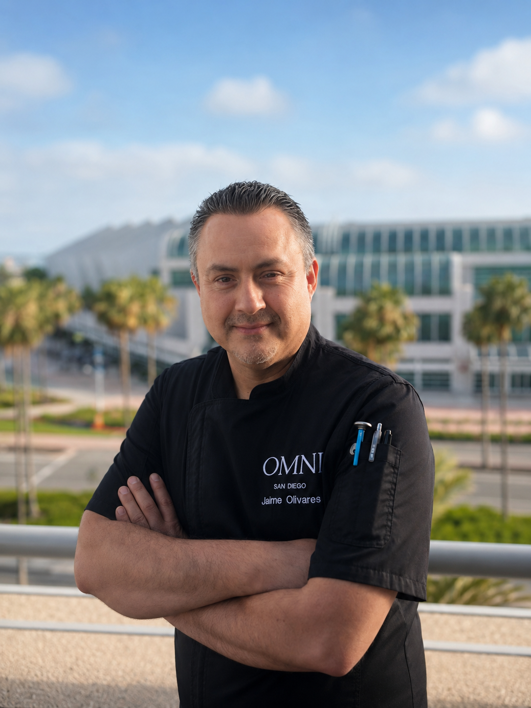 A headshot of Jaime Olivares in a black chef’s uniform.
